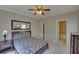 Comfortable bedroom adjacent to a bathroom and mirror with neutral walls at 5224 Brendlynn Dr, Suwanee, GA 30024