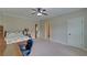 Spacious bedroom featuring neutral walls, carpeted floors, and ceiling fan at 5224 Brendlynn Dr, Suwanee, GA 30024