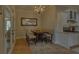 Cozy dining area with elegant chandelier, table seating for four, and ample natural light at 5224 Brendlynn Dr, Suwanee, GA 30024