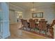 Formal dining room featuring a chandelier, decorative wallpaper, and hardwood floors at 5224 Brendlynn Dr, Suwanee, GA 30024