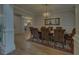 Elegant dining room featuring hardwood floors, decorative wallpaper, and a chandelier at 5224 Brendlynn Dr, Suwanee, GA 30024