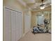 Home gym includes exercise machine and mirrored wall for effective workout space at 5224 Brendlynn Dr, Suwanee, GA 30024