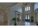 Grand foyer with soaring ceilings, hardwood floors, and elegant chandelier at 5224 Brendlynn Dr, Suwanee, GA 30024