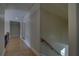 Hallway with wood floors and trim detail leads to stairs at 5224 Brendlynn Dr, Suwanee, GA 30024
