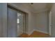 Hallway with hardwood floors, white trim, and views into a bedroom through an open door at 5224 Brendlynn Dr, Suwanee, GA 30024