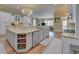 Spacious open kitchen featuring a central island, stainless appliances, and wood floors at 5224 Brendlynn Dr, Suwanee, GA 30024