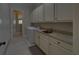 Functional laundry room equipped with a sink, granite countertops, and plenty of storage at 5224 Brendlynn Dr, Suwanee, GA 30024