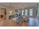Elegant living room features fireplace, chandelier, hardwood floors, and lots of natural light at 5224 Brendlynn Dr, Suwanee, GA 30024
