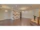 Open concept living room features stylish accent wall and elegant light fixtures at 5224 Brendlynn Dr, Suwanee, GA 30024