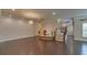 Spacious living room with hardwood floors, recessed lighting, and staircase detail at 5224 Brendlynn Dr, Suwanee, GA 30024