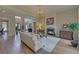 Comfortable living room with fireplace, chandelier, hardwood floors and view to entry at 5224 Brendlynn Dr, Suwanee, GA 30024