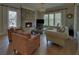 Inviting living room features a stone fireplace, hardwood floors, and abundant natural light at 5224 Brendlynn Dr, Suwanee, GA 30024