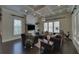 Comfortable living room with a coffered ceiling, dark hardwood floors, and a view of the backyard at 5224 Brendlynn Dr, Suwanee, GA 30024