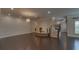 Open floor plan showcasing dark hardwood floors, recessed lighting, and a staircase at 5224 Brendlynn Dr, Suwanee, GA 30024