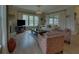Comfortable living room with fireplace, TV, large windows, and access to an outdoor deck at 5224 Brendlynn Dr, Suwanee, GA 30024