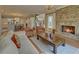 A cozy living room with a fireplace and an open concept kitchen in the background at 5224 Brendlynn Dr, Suwanee, GA 30024