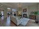 An open-concept living room boasts hardwood floors, a fireplace, and a view into the dining area at 5224 Brendlynn Dr, Suwanee, GA 30024