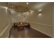 Inviting living room featuring a cozy sectional, hardwood floors, and recessed lighting at 5224 Brendlynn Dr, Suwanee, GA 30024