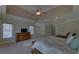 Expansive main bedroom with large windows, a seating area, and a tray ceiling with ceiling fan at 5224 Brendlynn Dr, Suwanee, GA 30024