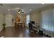 Well-lit office with a ceiling fan, natural light, modern furniture, and wood flooring at 5224 Brendlynn Dr, Suwanee, GA 30024