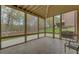 Enclosed porch with natural light, tiled flooring, and outdoor view at 5224 Brendlynn Dr, Suwanee, GA 30024