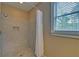 Shower with tile surround, built-in niche, and modern showerhead at 5224 Brendlynn Dr, Suwanee, GA 30024