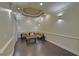Cozy sitting area with sectional sofa, custom wall lighting, and tray ceiling at 5224 Brendlynn Dr, Suwanee, GA 30024