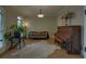 Cozy sitting room with hardwood floors, piano, and ample natural light from large windows at 5224 Brendlynn Dr, Suwanee, GA 30024