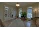 Bright sitting room featuring hardwood floors, French doors, and two large windows at 5224 Brendlynn Dr, Suwanee, GA 30024