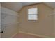 Neutral walk-in closet with wire shelves and a window for natural light at 5224 Brendlynn Dr, Suwanee, GA 30024