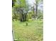Backyard featuring a white gazebo surrounded by tall trees and lush green grass at 1145 Crestview Ne Cir, Conyers, GA 30012