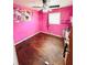 Pink bedroom featuring Hello Kitty decor, hardwood floors, and a ceiling fan at 1145 Crestview Ne Cir, Conyers, GA 30012