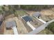 This aerial view showcases a home with a long driveway and well-kept yard in a suburban setting at 313 Bonnie Sue Dr, Villa Rica, GA 30180