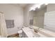 This bathroom has a white vanity with quartz countertop and large mirror above it at 313 Bonnie Sue Dr, Villa Rica, GA 30180