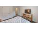 This bedroom shows the foot of the bed, a rustic dresser, and white doors at 313 Bonnie Sue Dr, Villa Rica, GA 30180