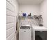The laundry room has a washer, dryer, ironing board, and shelves at 313 Bonnie Sue Dr, Villa Rica, GA 30180