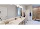Bright bathroom with double vanity, large mirror, and tiled walk-in shower featuring dual shower heads at 313 Bonnie Sue Dr, Villa Rica, GA 30180