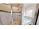Bathroom with tiled shower, separate tub, and large window offering plenty of natural light at 313 Bonnie Sue Dr, Villa Rica, GA 30180