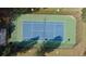 Aerial shot of a fenced tennis court with green and blue surface, perfect for recreational play at 313 Bonnie Sue Dr, Villa Rica, GA 30180
