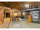 Unfinished basement space showing exposed beams, concrete floor, and shelving at 700 Henley Fields Cir, Johns Creek, GA 30097
