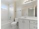 Bright bathroom with a white vanity, shower and tub combo at 700 Henley Fields Cir, Johns Creek, GA 30097