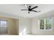 Bright bedroom with multiple windows and modern ceiling fan at 700 Henley Fields Cir, Johns Creek, GA 30097