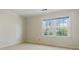 Neutral bedroom with large window and carpeted floor at 700 Henley Fields Cir, Johns Creek, GA 30097