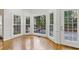 Bright breakfast nook with hardwood floors, large windows, and access to the outdoor deck at 700 Henley Fields Cir, Johns Creek, GA 30097