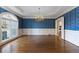 Elegant dining room with hardwood floors, decorative wallpaper, and a large window at 700 Henley Fields Cir, Johns Creek, GA 30097