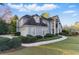 Elegant two-story home with manicured landscaping, a circular driveway, and attached garage at 700 Henley Fields Cir, Johns Creek, GA 30097