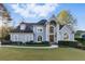 Charming two-story traditional home featuring a well-manicured front lawn and a symmetrical facade at 700 Henley Fields Cir, Johns Creek, GA 30097