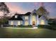 Traditional two-story home with a landscaped lawn and elegant architectural details at 700 Henley Fields Cir, Johns Creek, GA 30097