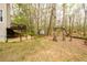 View of the fenced-in backyard, storage shed, and the home's wooden deck at 1885 Oak Wind Ln, Buford, GA 30519