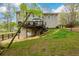 View of the home's backyard with a wooden deck and fenced yard at 1885 Oak Wind Ln, Buford, GA 30519